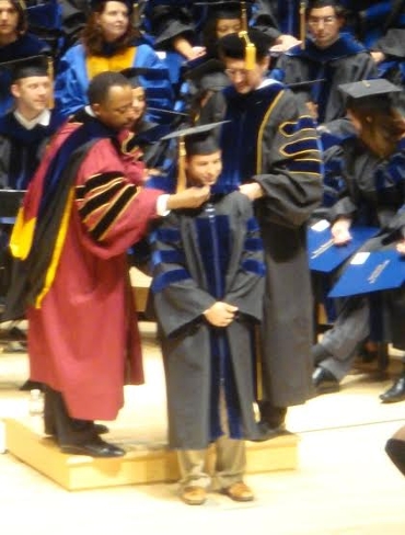 Christopher Vellano hooding at graduation